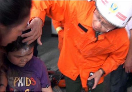 Schoolboy head stuck between concrete