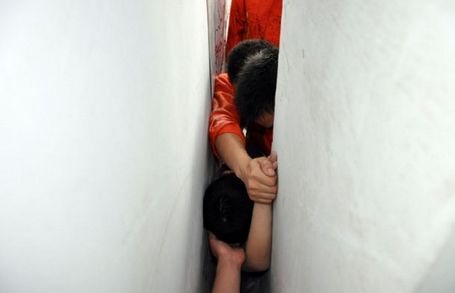 Schoolboy head between walls